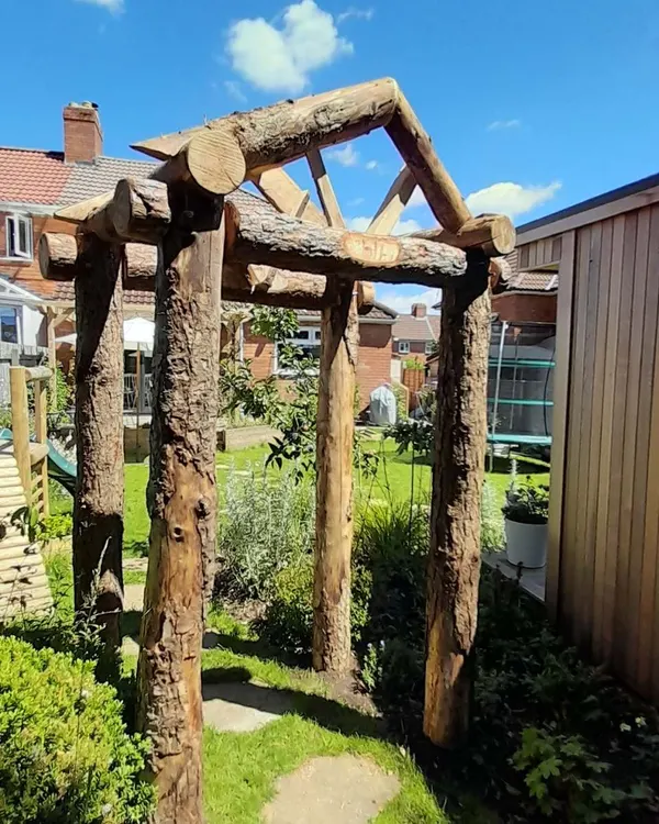 Rustic timber arch built from a large tree section - Monkey Business Design