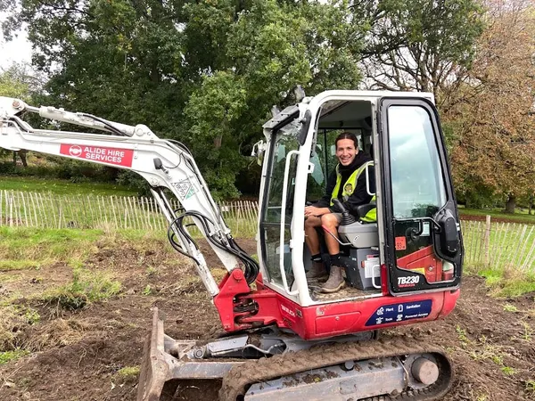 Joby operating a mini digger during groundworks - Monkey Business Design